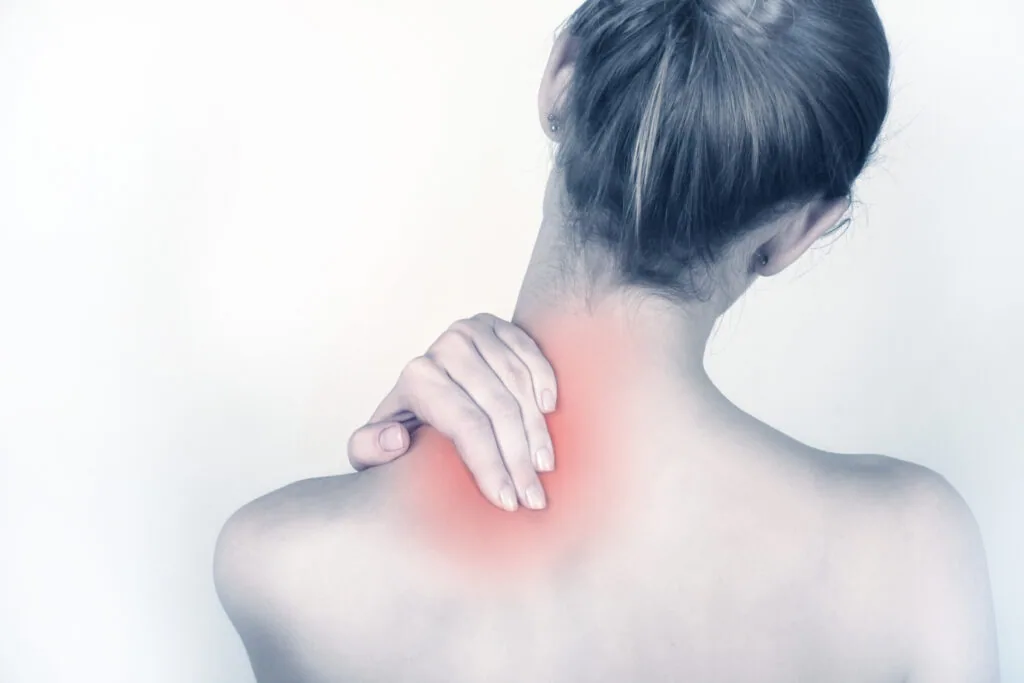 Woman touching shoulder with hand, red highlighted area indicating pain or injury